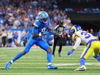 DETROIT,MICHIGAN-SEPTEMBER 8: Detroit Lions wide receiver Jameson Williams (9) runs the ball during the second half of an NFL football game...