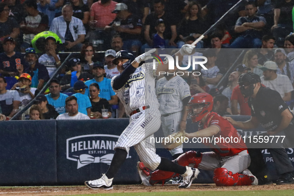 Christian Villanueva #14 of Sultanes de Monterrey hits the ball during the 2024 King Series match 3 against Diablos Rojos of the Mexican Bas...