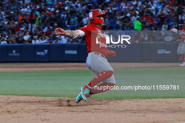 Juan Carlos Gamboa #47 of Diablos Rojos slides to the third base plate during the 2024 King Series match 3 against Sultanes de Monterrey of...