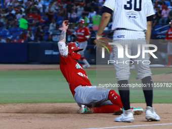 Juan Carlos Gamboa #47 of Diablos Rojos slides to the third base plate during the 2024 King Series match 3 against Sultanes de Monterrey of...