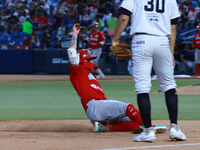 Juan Carlos Gamboa #47 of Diablos Rojos slides to the third base plate during the 2024 King Series match 3 against Sultanes de Monterrey of...