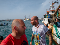 Sailors dive into the sea to greet the statue of Our Lady of Martyrs on the occasion of the patronal feast day in Molfetta, Italy, on Septem...