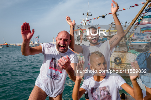 Sailors celebrate and dive into the sea to greet the statue of Our Lady of Martyrs on the occasion of the patronal feast day in Molfetta, It...