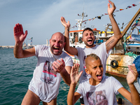 Sailors celebrate and dive into the sea to greet the statue of Our Lady of Martyrs on the occasion of the patronal feast day in Molfetta, It...