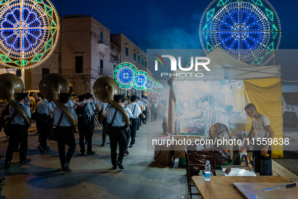 The band opens the procession in Via Dante among the stalls on the occasion of the patron saint's day in Molfetta, Italy, on September 8, 20...