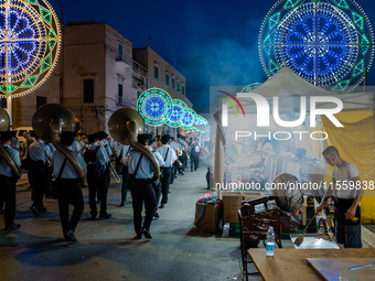 The band opens the procession in Via Dante among the stalls on the occasion of the patron saint's day in Molfetta, Italy, on September 8, 20...