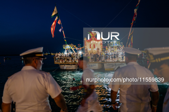 The statue of Our Lady of Martyrs is withdrawn from the sea on three fishing boats accompanied by sailors on the occasion of the patronal fe...