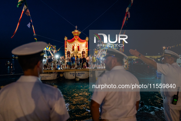 The statue of Our Lady of Martyrs is withdrawn from the sea on three fishing boats accompanied by sailors on the occasion of the patronal fe...