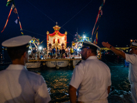 The statue of Our Lady of Martyrs is withdrawn from the sea on three fishing boats accompanied by sailors on the occasion of the patronal fe...