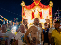 Sailors stand in front of the statue of Our Lady of Martyrs on the occasion of the patronal feast day in Molfetta, Italy, on September 8, 20...