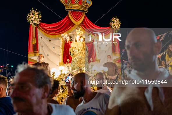 Sailors stand in front of the statue of Our Lady of Martyrs on the occasion of the patronal feast day in Molfetta, Italy, on September 8, 20...