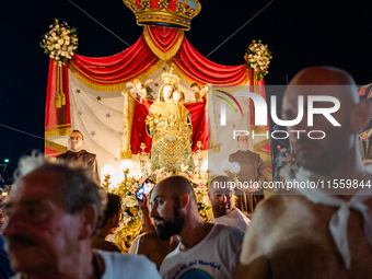 Sailors stand in front of the statue of Our Lady of Martyrs on the occasion of the patronal feast day in Molfetta, Italy, on September 8, 20...