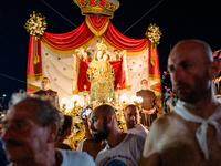 Sailors stand in front of the statue of Our Lady of Martyrs on the occasion of the patronal feast day in Molfetta, Italy, on September 8, 20...