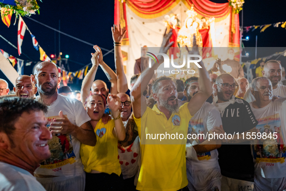 Sailors celebrate in front of the statue of Our Lady of Martyrs on the occasion of the patronal feast day in Molfetta, Italy, on September 8...