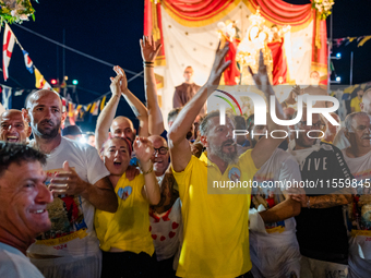 Sailors celebrate in front of the statue of Our Lady of Martyrs on the occasion of the patronal feast day in Molfetta, Italy, on September 8...