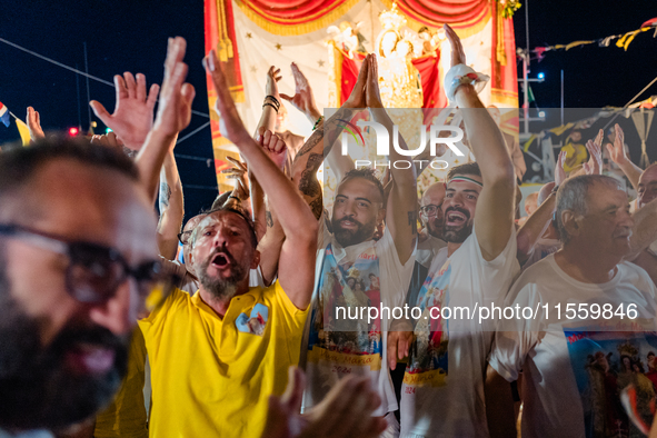 Sailors celebrate in front of the statue of Our Lady of Martyrs on the occasion of the patronal feast day in Molfetta, Italy, on September 8...