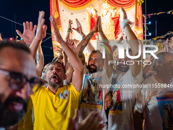 Sailors celebrate in front of the statue of Our Lady of Martyrs on the occasion of the patronal feast day in Molfetta, Italy, on September 8...