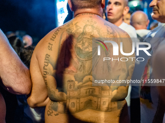 A sailor has a tattoo of the statue of Our Lady of Martyrs on his shoulder on the occasion of the patronal feast day in Molfetta, Italy, on...