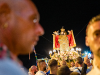 Sailors stand in front of the statue of Our Lady of Martyrs on the occasion of the patronal feast day in Molfetta, Italy, on September 8, 20...