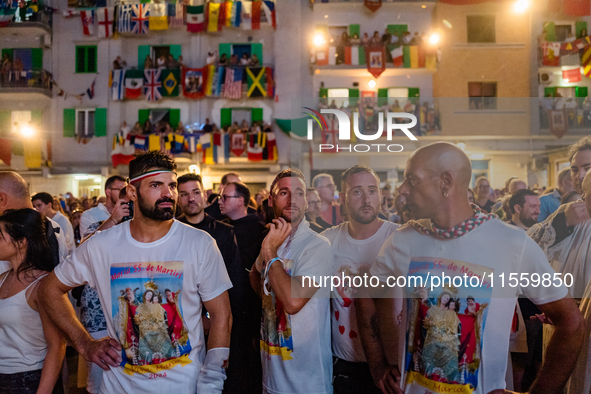 Sailors stand in front of the statue of Our Lady of Martyrs on the occasion of the patronal feast day in Molfetta, Italy, on September 8, 20...