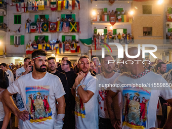 Sailors stand in front of the statue of Our Lady of Martyrs on the occasion of the patronal feast day in Molfetta, Italy, on September 8, 20...