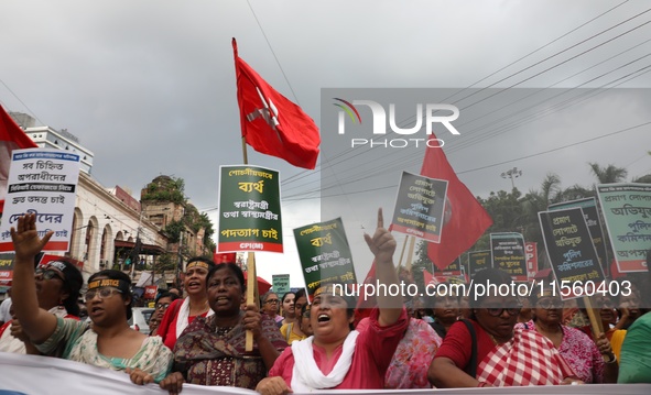 Activists shout slogans during heavy monsoon rain during a protest rally towards Kolkata Police Headquarters, Lalbazar, organized by the Com...