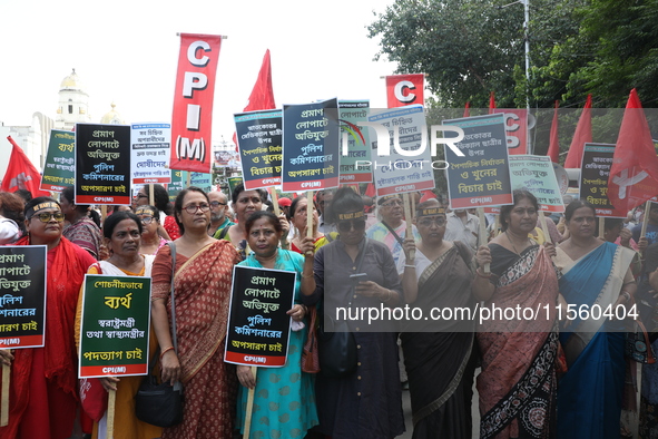 Activists shout slogans during heavy monsoon rain during a protest rally towards Kolkata Police Headquarters, Lalbazar, organized by the Com...