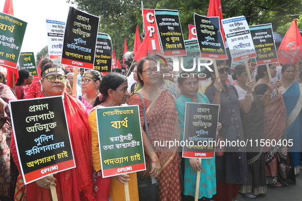 Activists shout slogans during heavy monsoon rain during a protest rally towards Kolkata Police Headquarters, Lalbazar, organized by the Com...