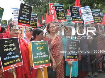 Activists shout slogans during heavy monsoon rain during a protest rally towards Kolkata Police Headquarters, Lalbazar, organized by the Com...