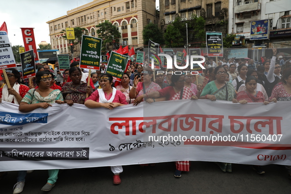 Activists shout slogans during heavy monsoon rain during a protest rally towards Kolkata Police Headquarters, Lalbazar, organized by the Com...