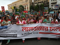 Activists shout slogans during heavy monsoon rain during a protest rally towards Kolkata Police Headquarters, Lalbazar, organized by the Com...