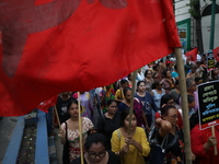 Activists shout slogans during heavy monsoon rain during a protest rally towards Kolkata Police Headquarters, Lalbazar, organized by the Com...