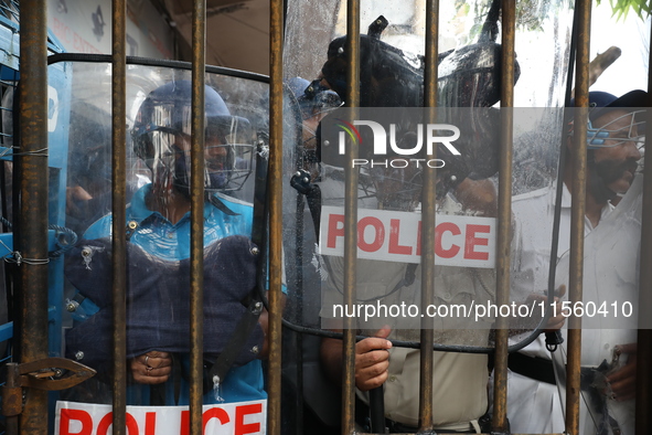 Activists shout slogans during heavy monsoon rain during a protest rally towards Kolkata Police Headquarters, Lalbazar, organized by the Com...