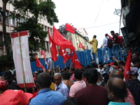 Activists shout slogans during heavy monsoon rain during a protest rally towards Kolkata Police Headquarters, Lalbazar, organized by the Com...