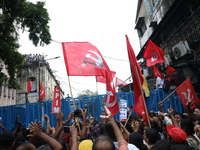 Activists shout slogans during heavy monsoon rain during a protest rally towards Kolkata Police Headquarters, Lalbazar, organized by the Com...