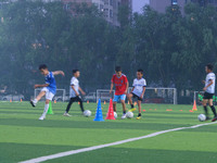 Children practice soccer at the evening soccer field of Capital Sport University in Beijing, China, on September 9, 2024. (