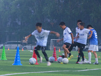 Children practice soccer at the evening soccer field of Capital Sport University in Beijing, China, on September 9, 2024. (