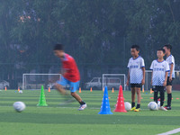 Children practice soccer at the evening soccer field of Capital Sport University in Beijing, China, on September 9, 2024. (