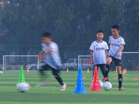 Children practice soccer at the evening soccer field of Capital Sport University in Beijing, China, on September 9, 2024. (