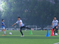 Children practice soccer at the evening soccer field of Capital Sport University in Beijing, China, on September 9, 2024. (