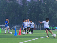 Children practice soccer at the evening soccer field of Capital Sport University in Beijing, China, on September 9, 2024. (