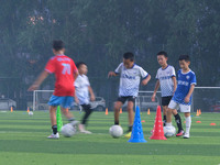 Children practice soccer at the evening soccer field of Capital Sport University in Beijing, China, on September 9, 2024. (