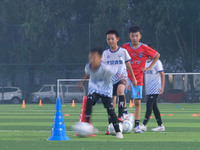 Children practice soccer at the evening soccer field of Capital Sport University in Beijing, China, on September 9, 2024. (