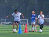 Children practice soccer at the evening soccer field of Capital Sport University in Beijing, China, on September 9, 2024. (