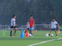 Children practice soccer at the evening soccer field of Capital Sport University in Beijing, China, on September 9, 2024. (