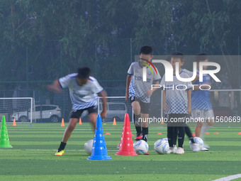 Children practice soccer at the evening soccer field of Capital Sport University in Beijing, China, on September 9, 2024. (