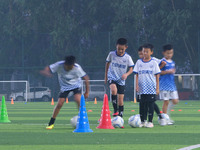 Children practice soccer at the evening soccer field of Capital Sport University in Beijing, China, on September 9, 2024. (