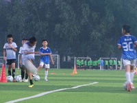 Children practice soccer at the evening soccer field of Capital Sport University in Beijing, China, on September 9, 2024. (