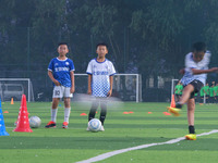 Children practice soccer at the evening soccer field of Capital Sport University in Beijing, China, on September 9, 2024. (