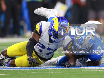 DETROIT,MICHIGAN-SEPTEMBER 8: Tight end Sam LaPorta (87) of the Detroit Lions is brought down by cornerback Tre'Davious White (27) of the Lo...